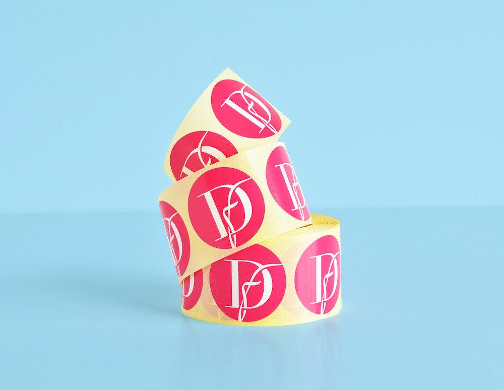 Custom made pink stickers on a roll