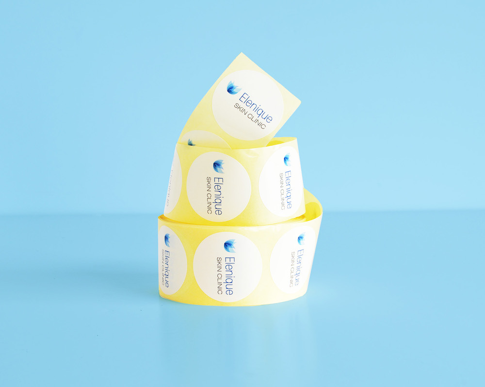 White custom printed stickers on a roll