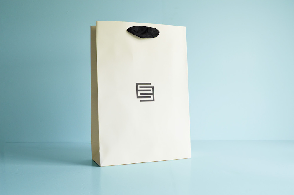 Cream custom made ribbon handle paper bag with black ribbon handle