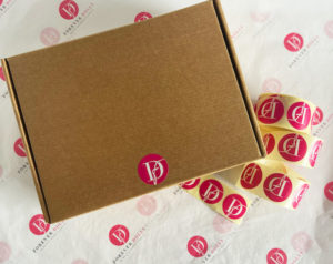 custom printed pink stickers on mailing box packaging