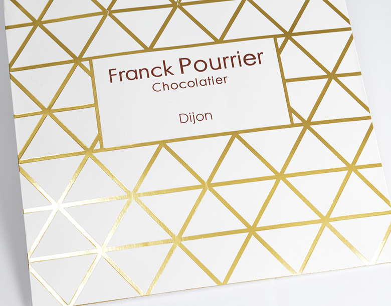 Custom printed white paper bag with gold pattern and ribbon handles