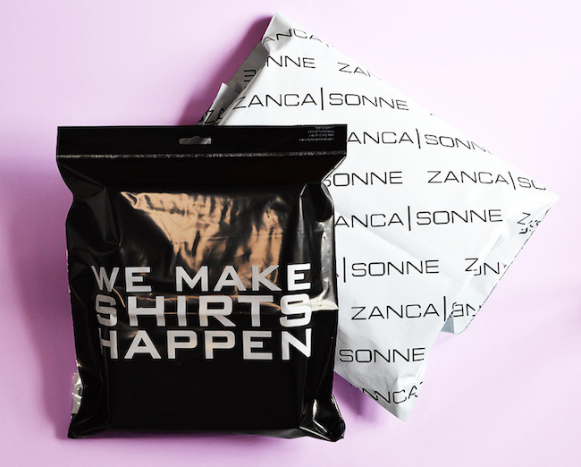 custom printed mailing bags in black and white on pink background