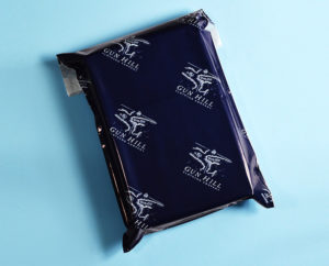 custom printed navy mailing bag with white logo repeated on blue background